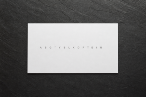 Printed peptide sequence card on charcoal slate, laboratory stationery still life